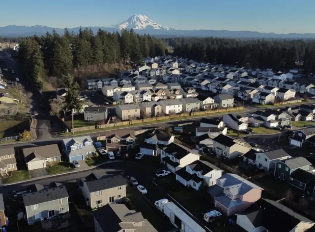 A suburb in spanaway washington with homes from eye to eye with Mt. Rainier in the far background