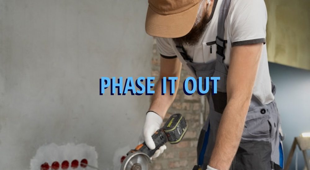 Man working on wood cutting it with caption over it reading, 'phase it out' in reference to remodels.